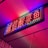 A vibrant, neon sign with red characters outlined by blue and green lights. It is mounted on a wall and the lighting creates a colorful glow on the surrounding area.