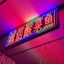 A vibrant neon sign showcasing a client's logo.