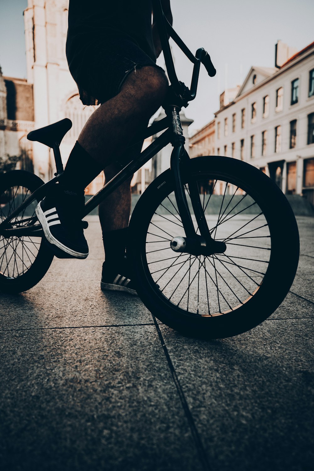 grayscale photo of person riding bicycle