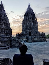Ancient temples silhouetted against a darkened sky during eclipse.