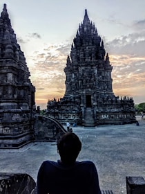 Ancient temples silhouetted against a darkened sky during eclipse.
