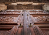 A close-up of a beautifully carved wooden door with intricate detailing.