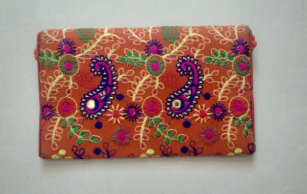 A handkerchief featuring intricate traditional Indian embroidery in vibrant colors.