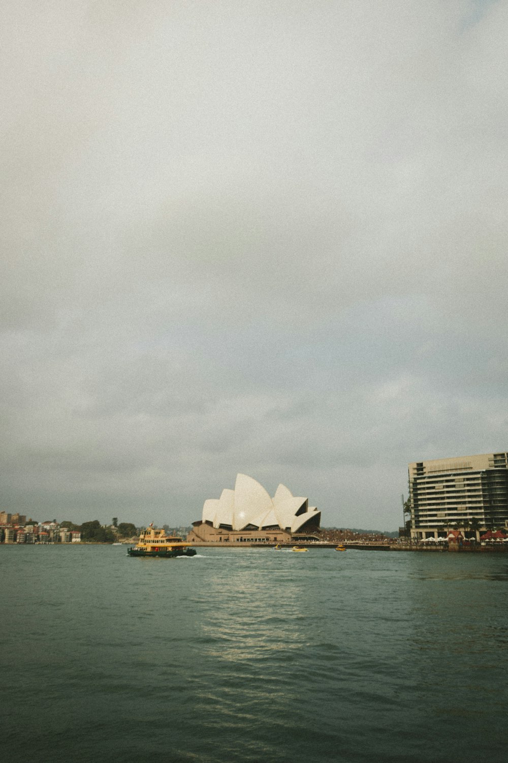 white and brown concrete building near body of water during daytime