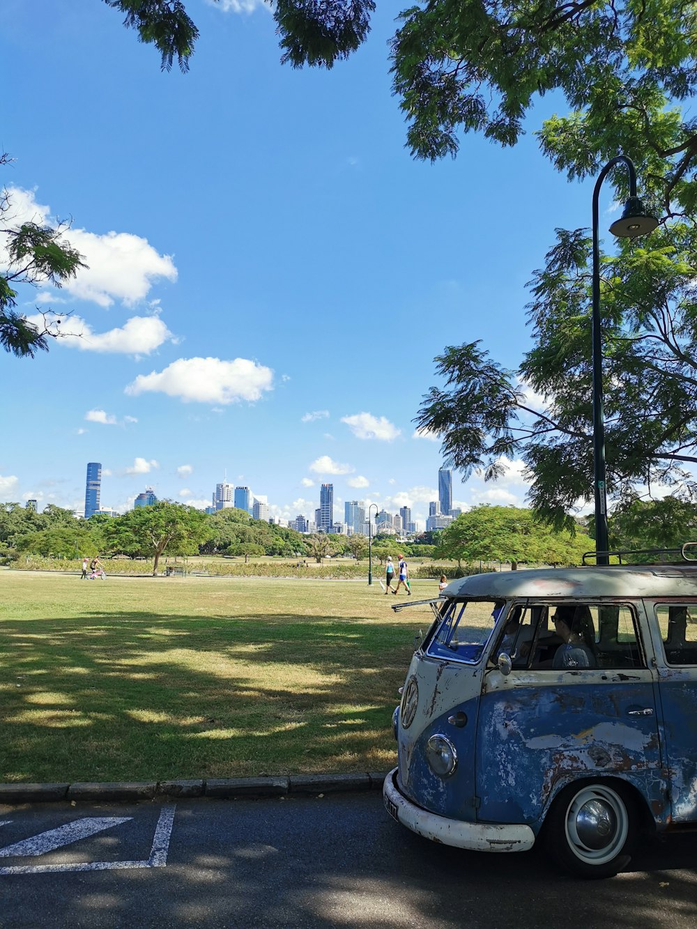 blue suv on green grass field during daytime