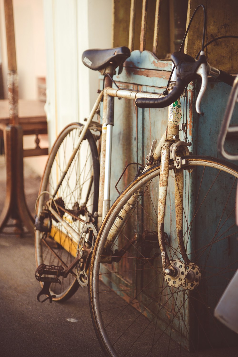 black bicycle with brown steel fence