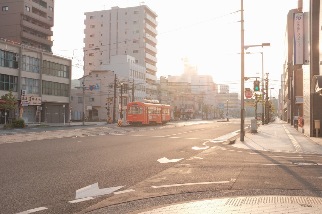 red bus on road during daytime