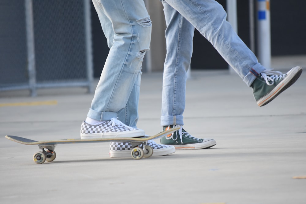 person in blue denim jeans and blue and white sneakers