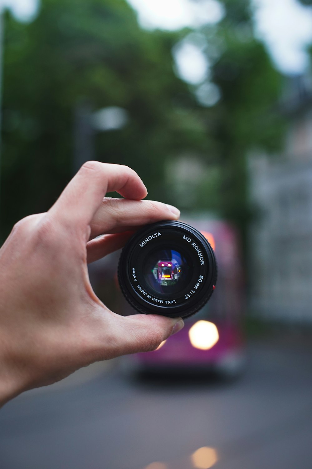 person holding black camera lens