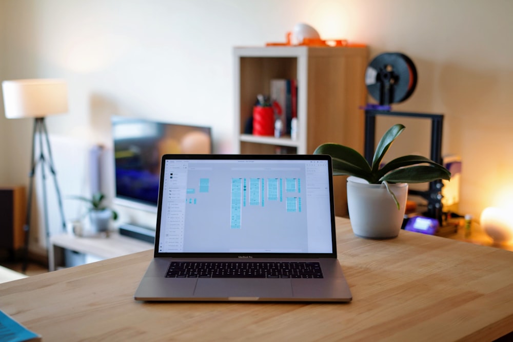 macbook pro on brown wooden table