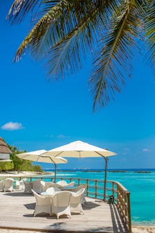 white patio umbrella near beach during daytime