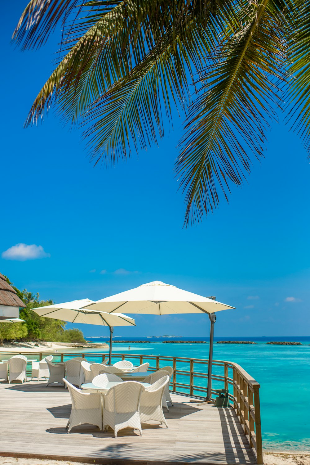 white patio umbrella near beach during daytime