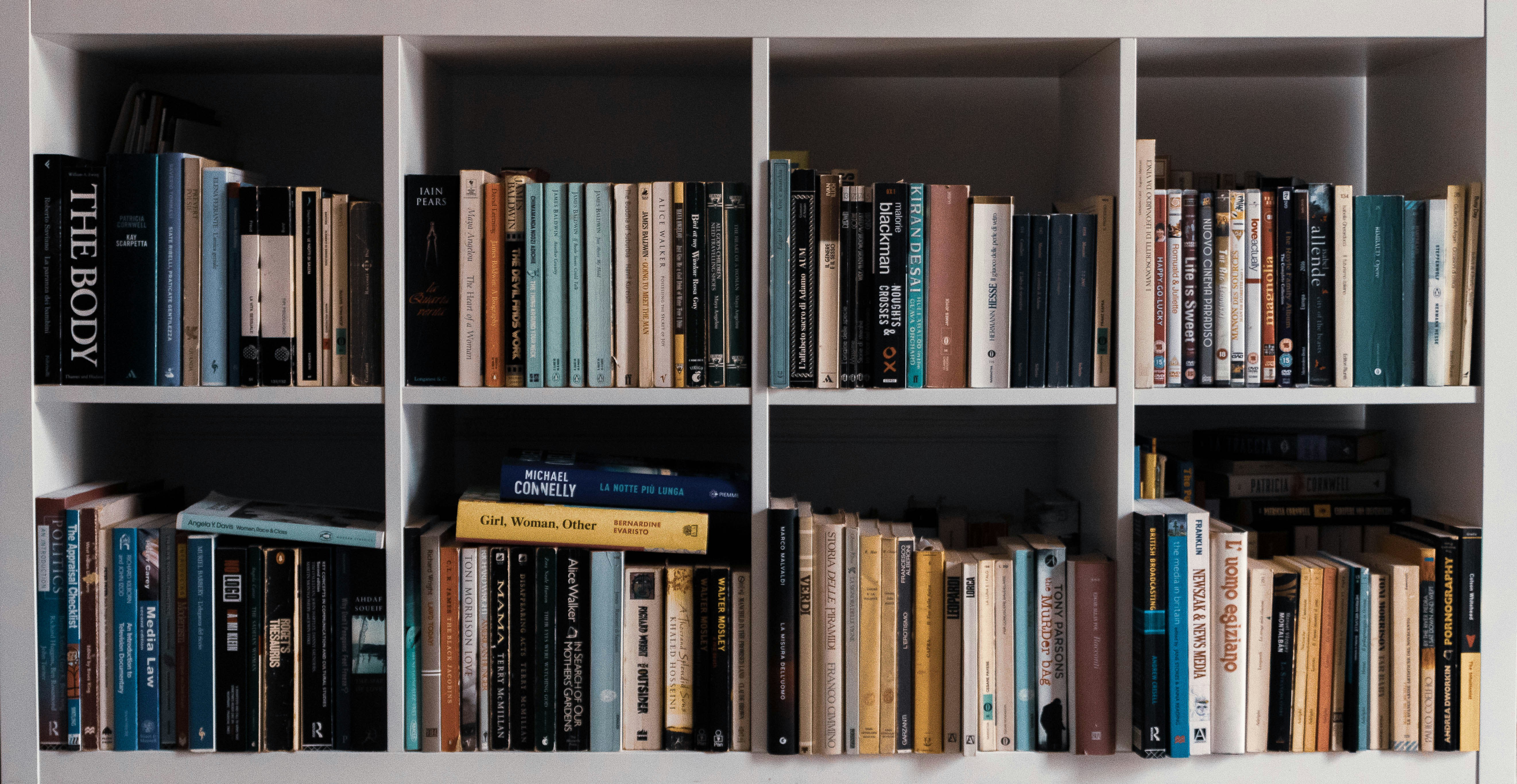 books on white wooden shelf