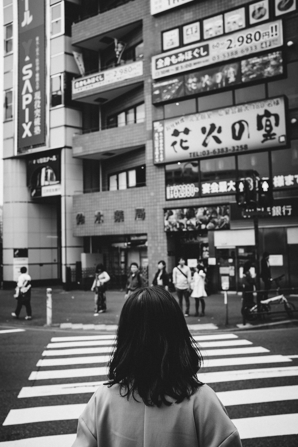 grayscale photo of people walking on pedestrian lane