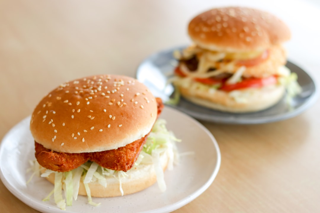 burger on white ceramic plate, Chicken and Beef Burgers<p></figure>