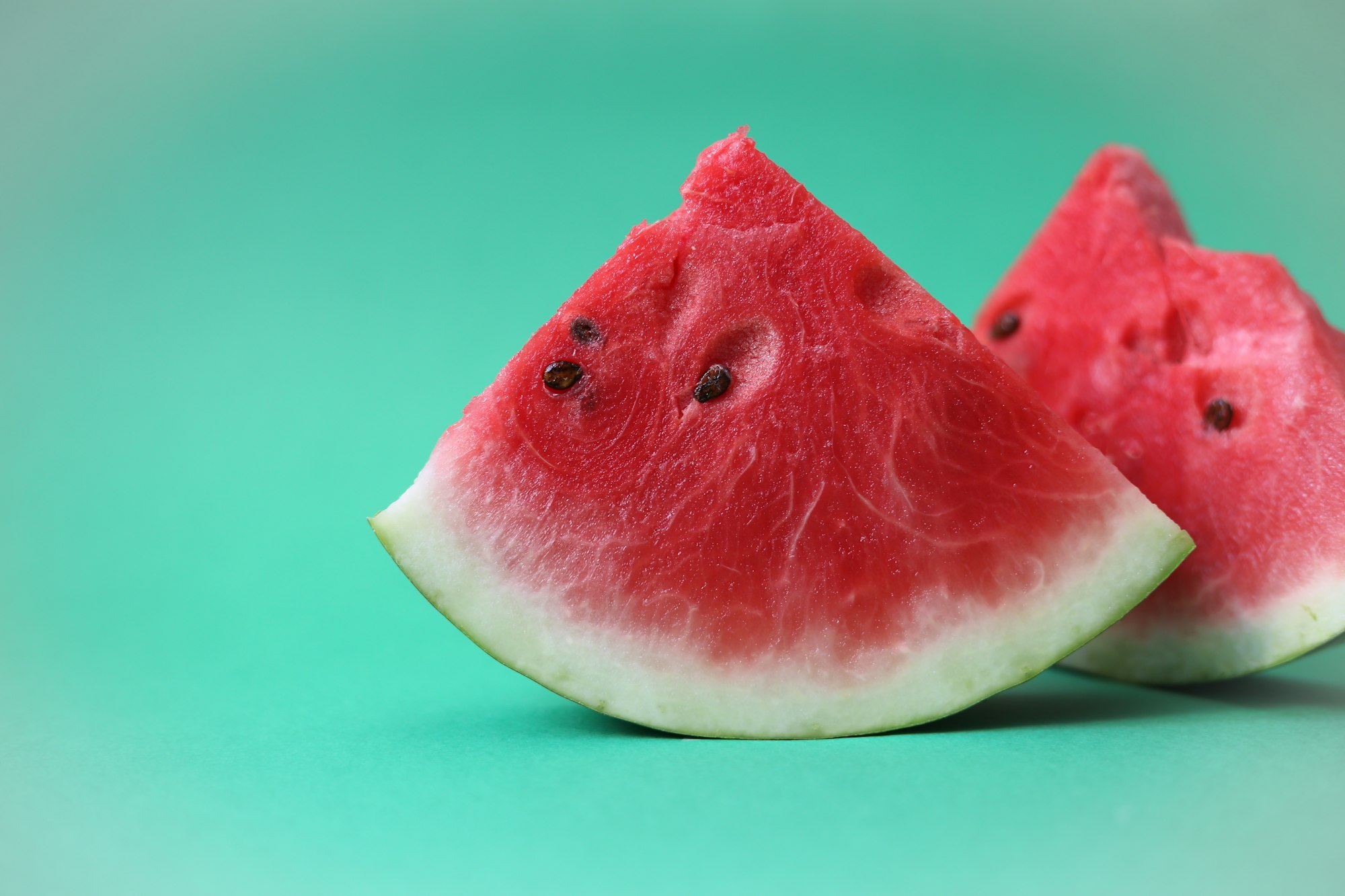 Watermelon slices on green background