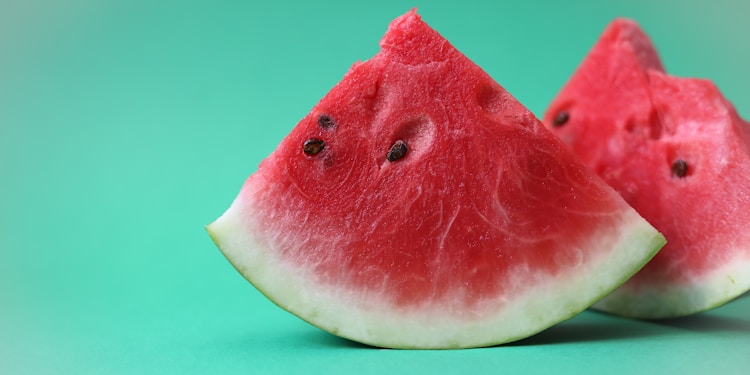 sliced watermelon on green surface