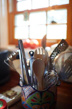 stainless steel spoons and forks on brown wooden table