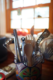 stainless steel spoons and forks on brown wooden table