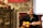Smiling young boy playing guitar during a lesson at a cozy home studio.