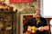 Photo of a young man happily playing acoustic guitar in a cozy home studio.