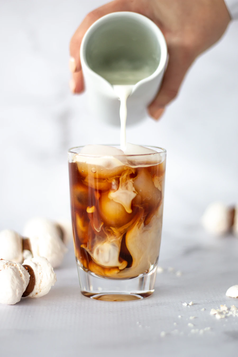 Iced coffee with ice cubes on a kitchen counter