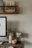 Close-up of a detailed Asian print hanging above a modern desk setup.