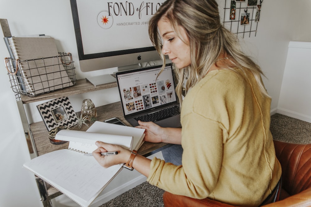 woman in brown long sleeve shirt holding white paper