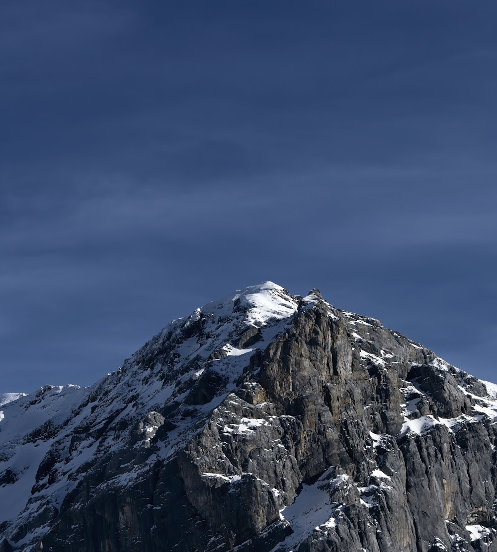 snow covered mountain under blue sky during daytime