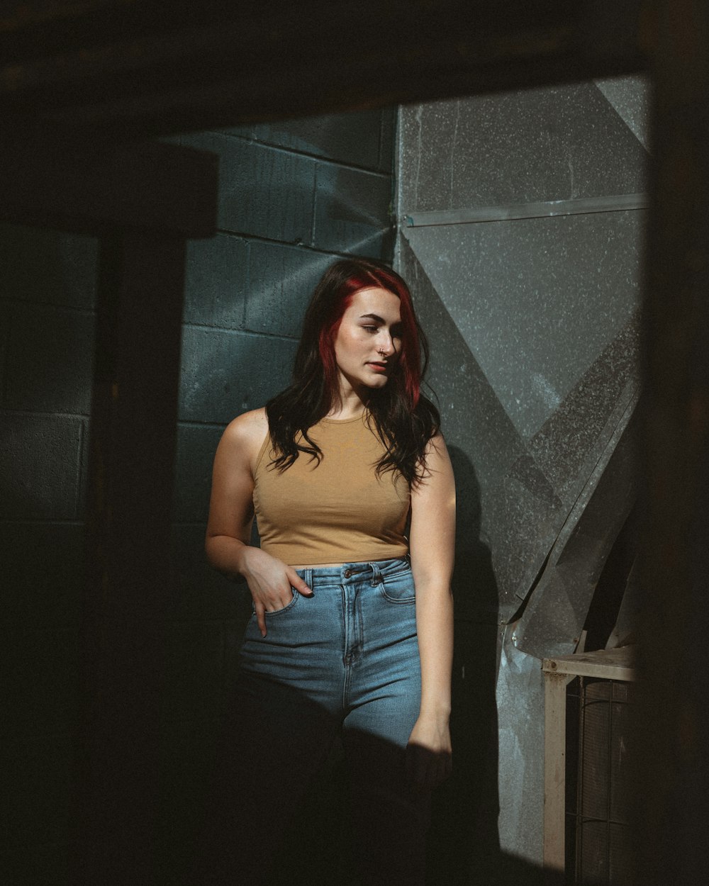 woman in brown tank top and blue denim jeans