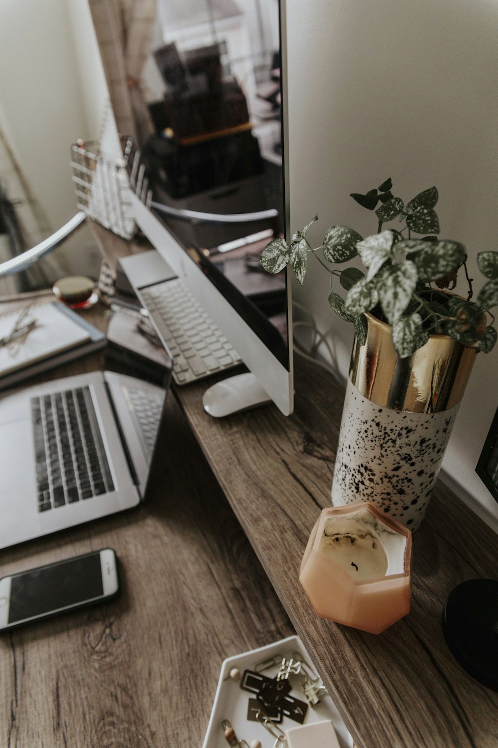 macbook pro beside brown wooden table