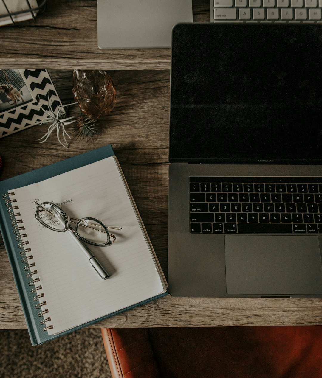 silver framed eyeglasses on macbook pro