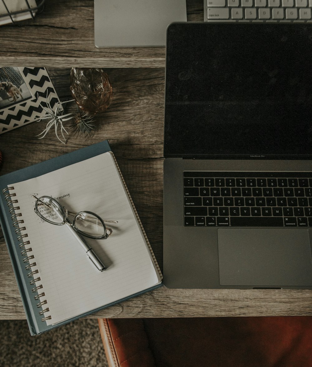 silver framed eyeglasses on macbook pro