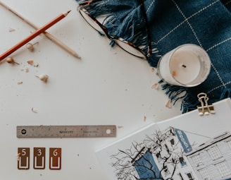 A serene workspace with coloring books and colored pencils spread out on a wooden table.
