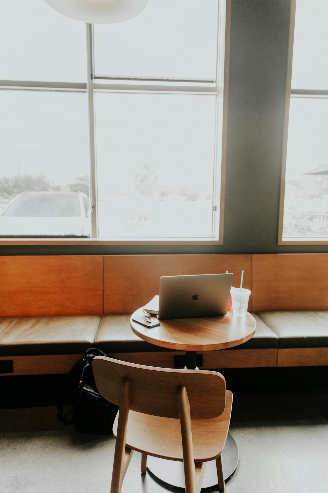 silver macbook on brown wooden table