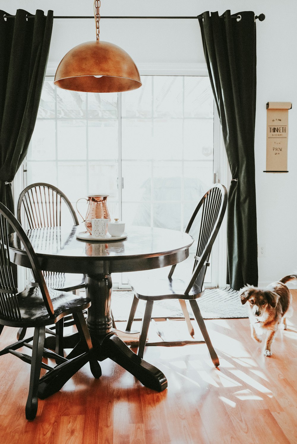 brown and white short coated dog on brown wooden round table