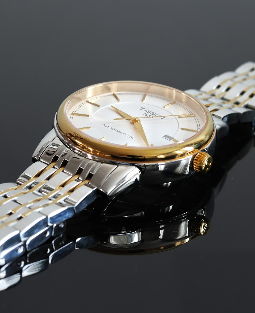 silver and gold analog watch
