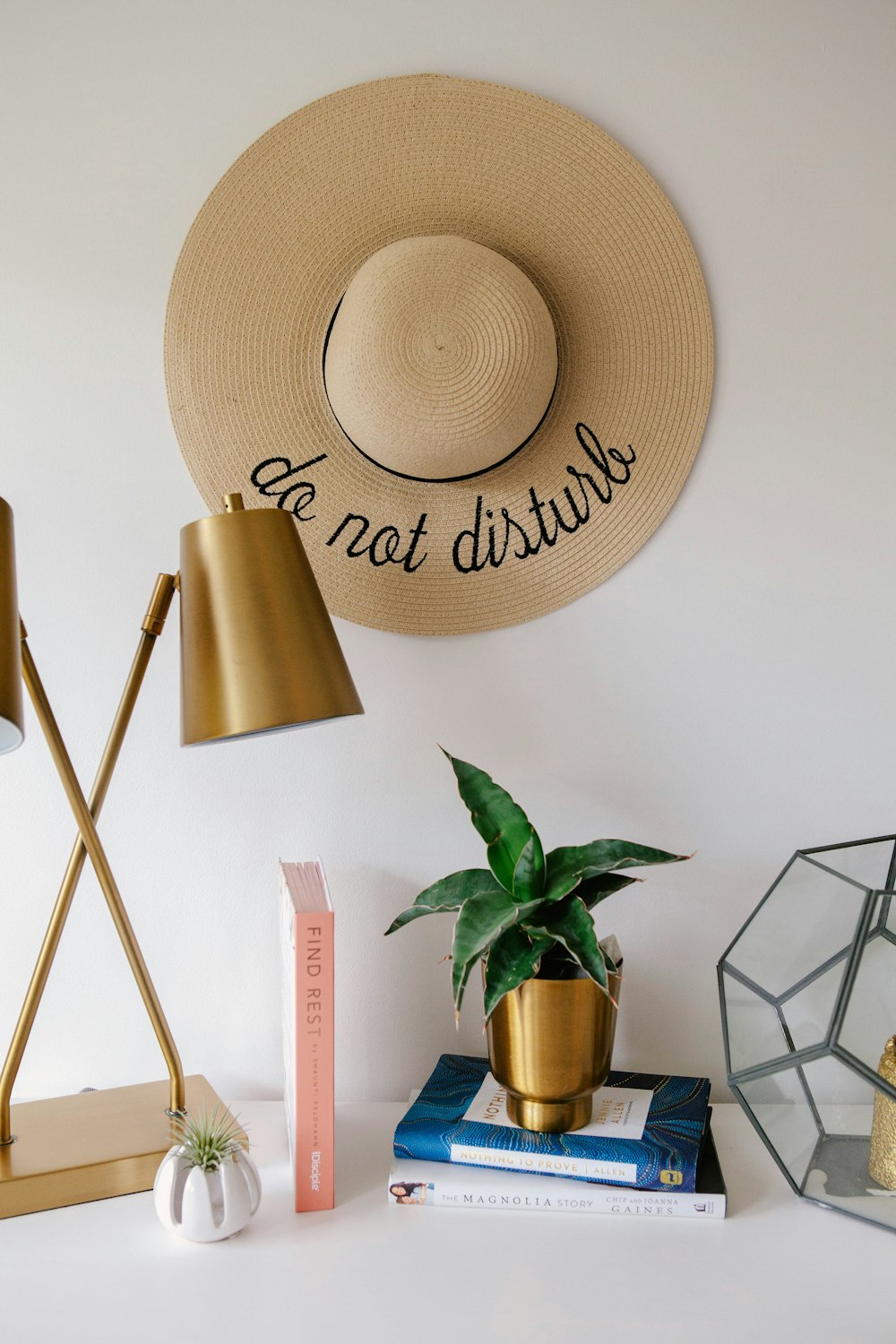 brown sun hat beside green potted plant