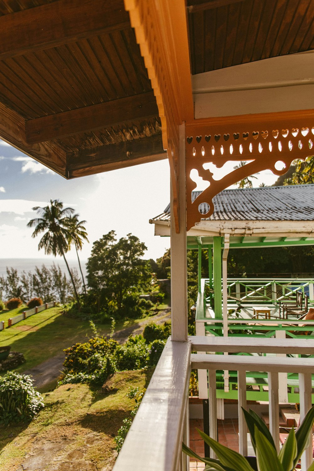 green and brown wooden gazebo near green trees during daytime