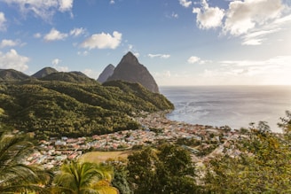 green mountain near body of water during daytime