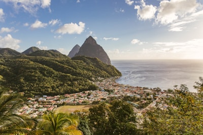green mountain near body of water during daytime