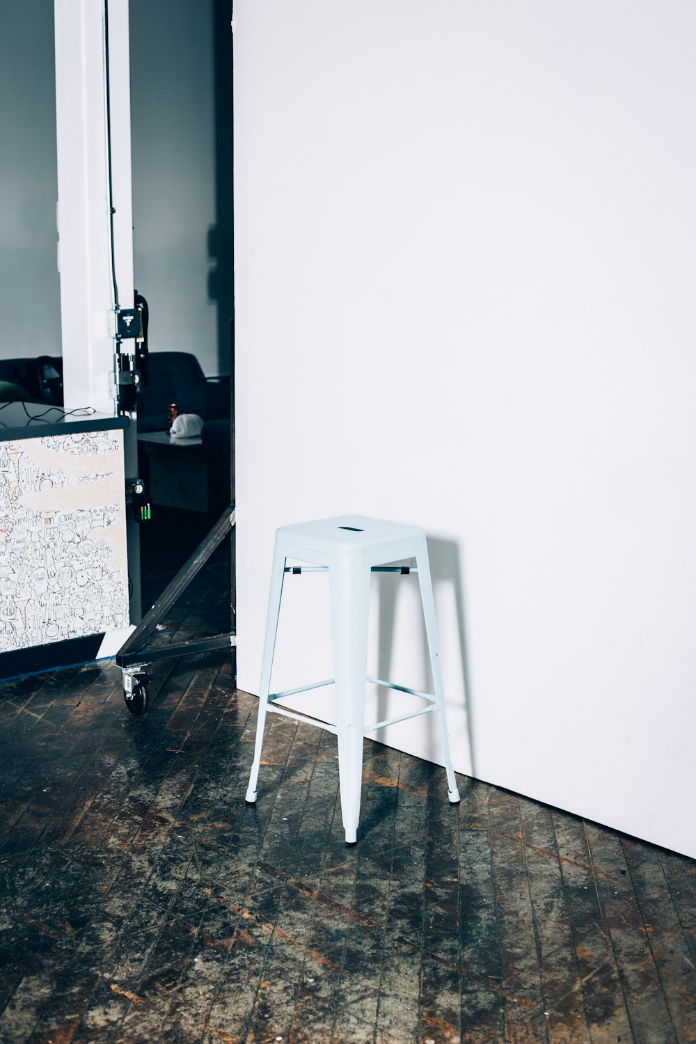 white wooden table beside white wall