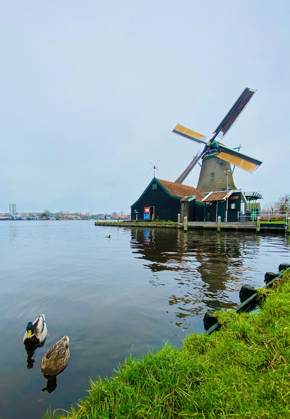 brown wooden house near body of water during daytime