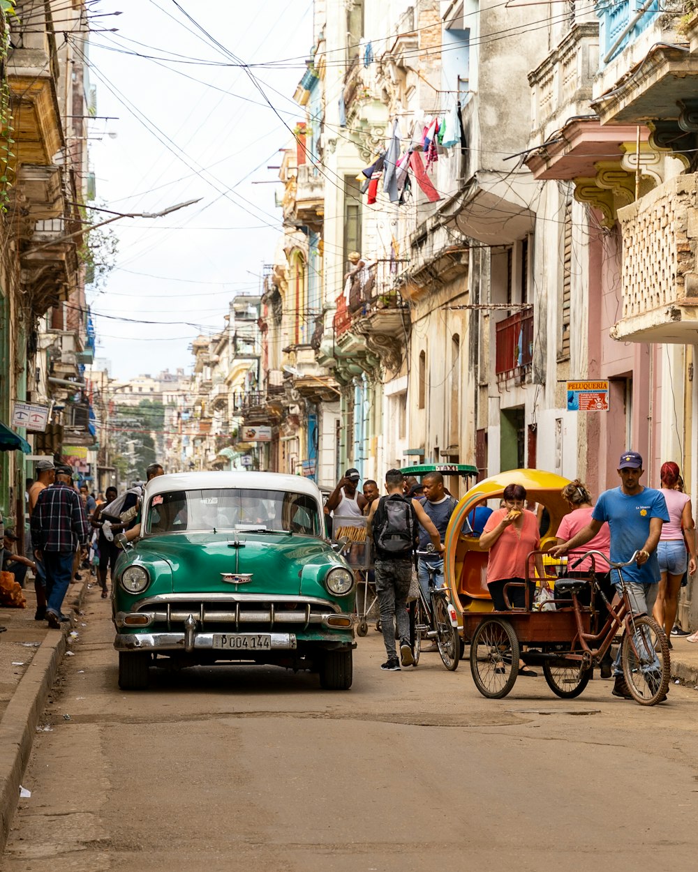 green and blue cars on road during daytime