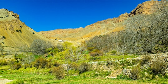 brown rocky mountain under blue sky during daytime in Ouarzazate Province Morocco