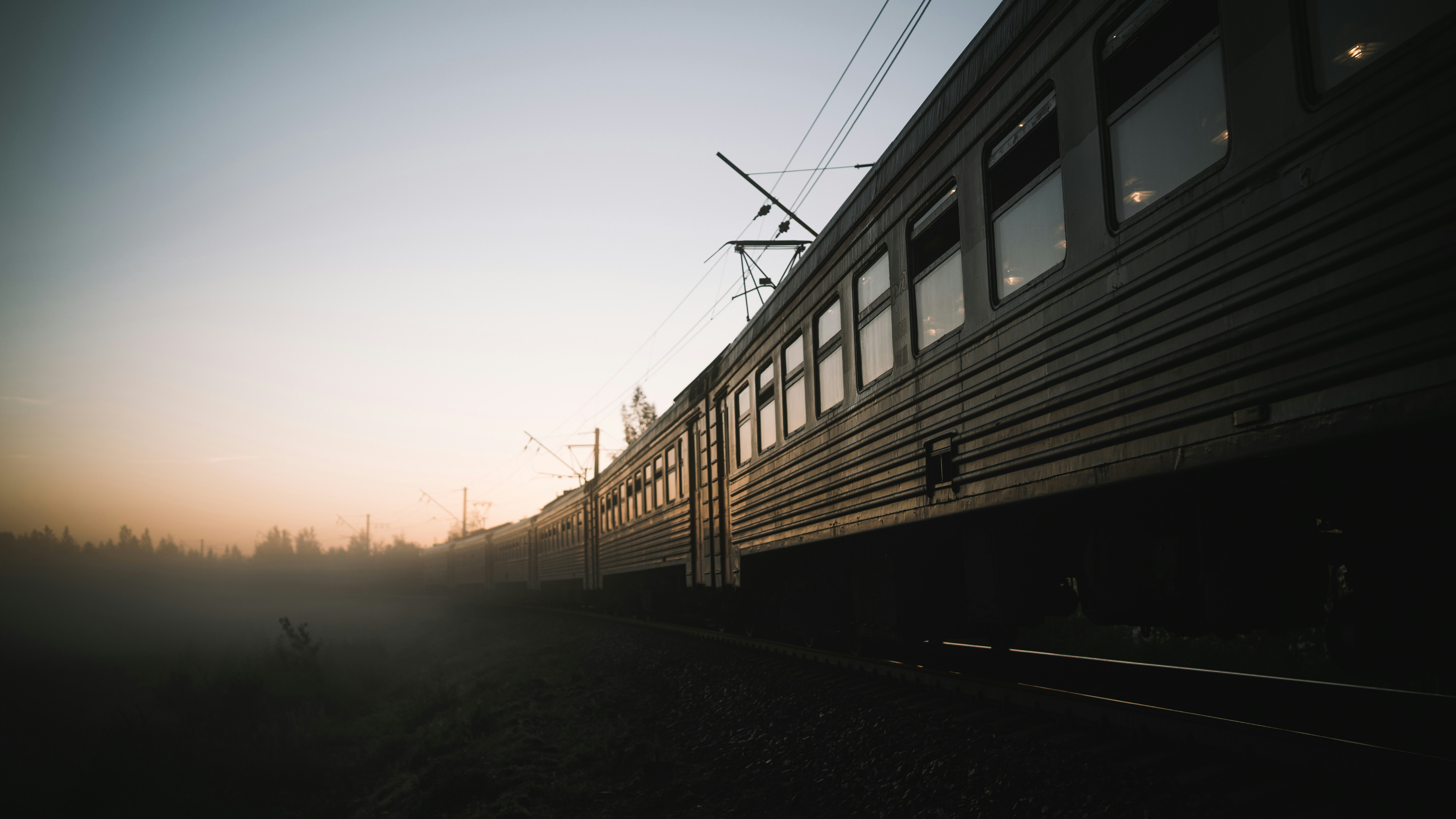 train on rail during sunset