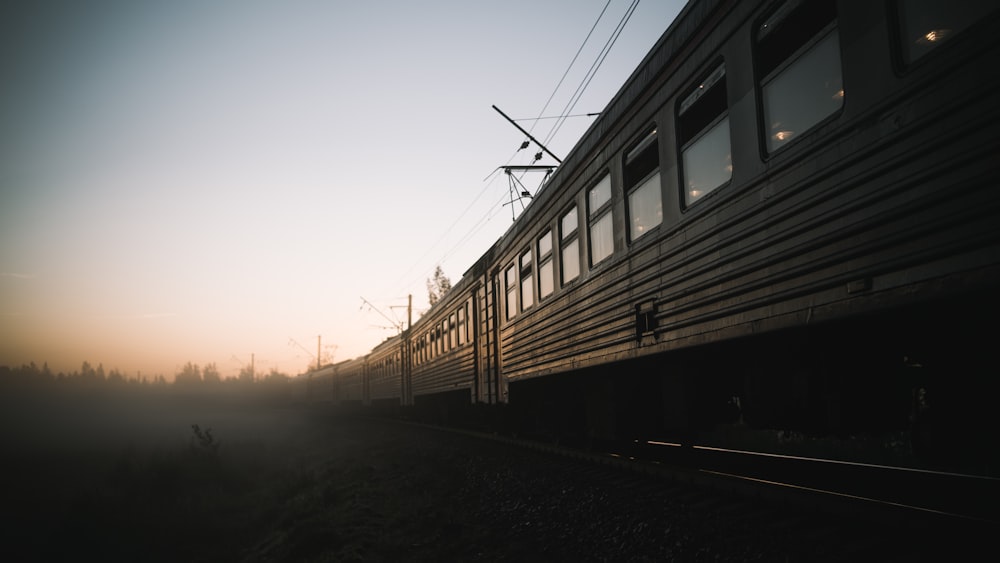 train on rail during sunset