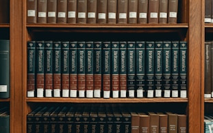 books on brown wooden shelf
