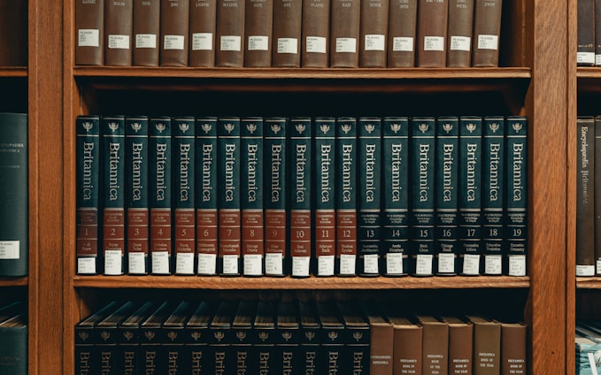 books on brown wooden shelf