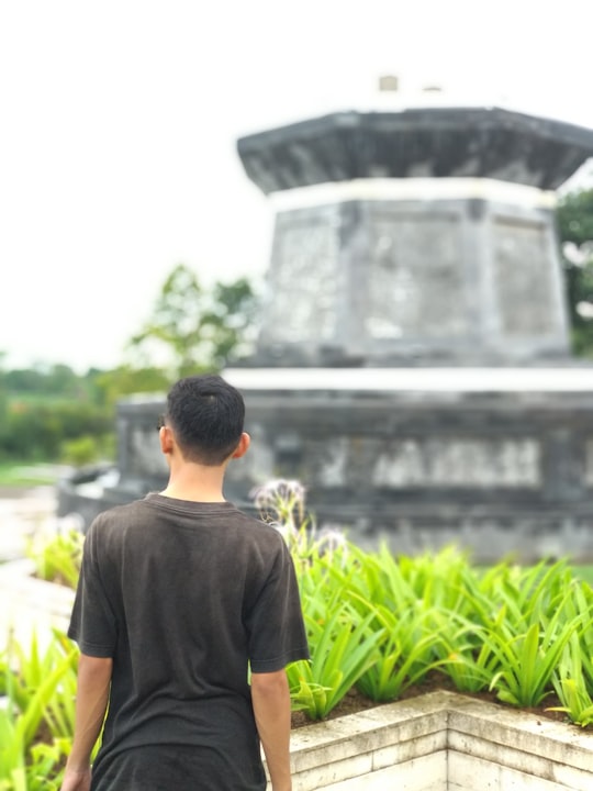 man in black crew neck t-shirt standing near green plants during daytime in Singaraja Metropolitan Area Indonesia